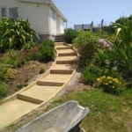 Wellington landscape transformation showing retaining walls and custom decking that increase property value